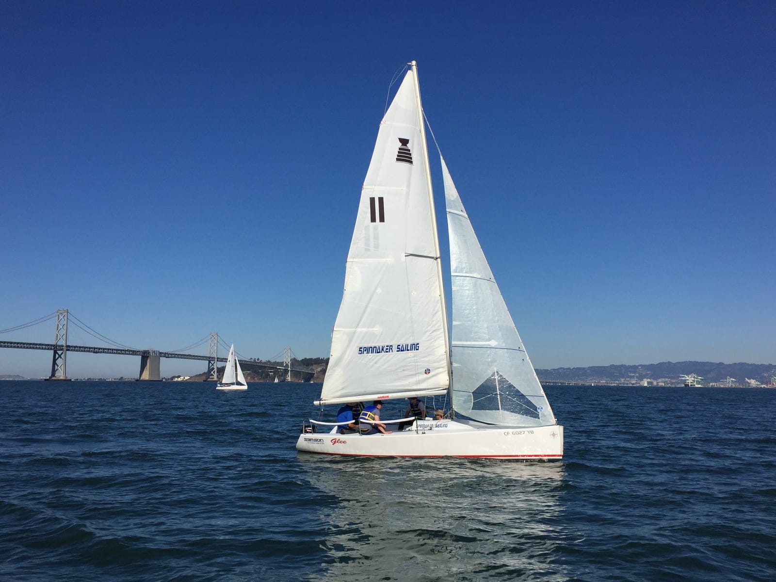 An Andrews 21 sailing on the Bay under a clear sky