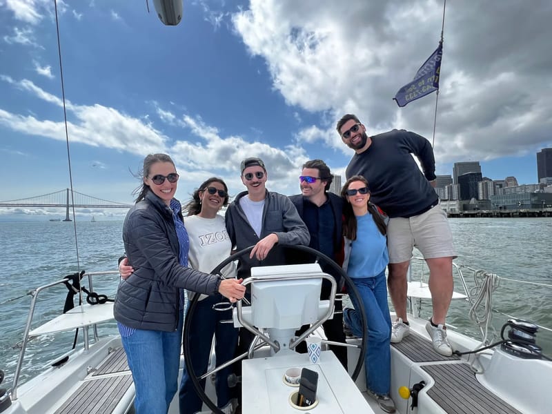 A group at Valkyrie's wheel with the city behind
