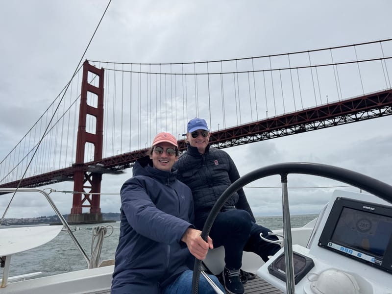 A couple at Valkyrie's helm beneath the Golden Gate Bridge