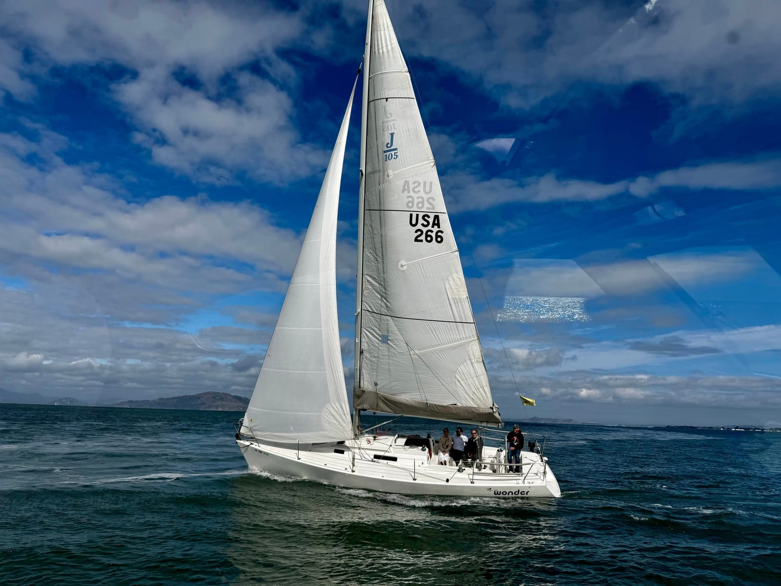 The J/105 Wonder sailing under a blue sky