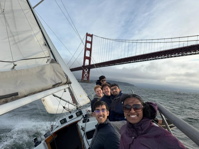 A crew aboard a J/105 passing under the Golden Gate Bridge