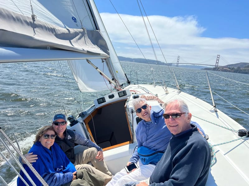 A crew relaxing in a J/105 cockpit, the Bay Bridge in the distance