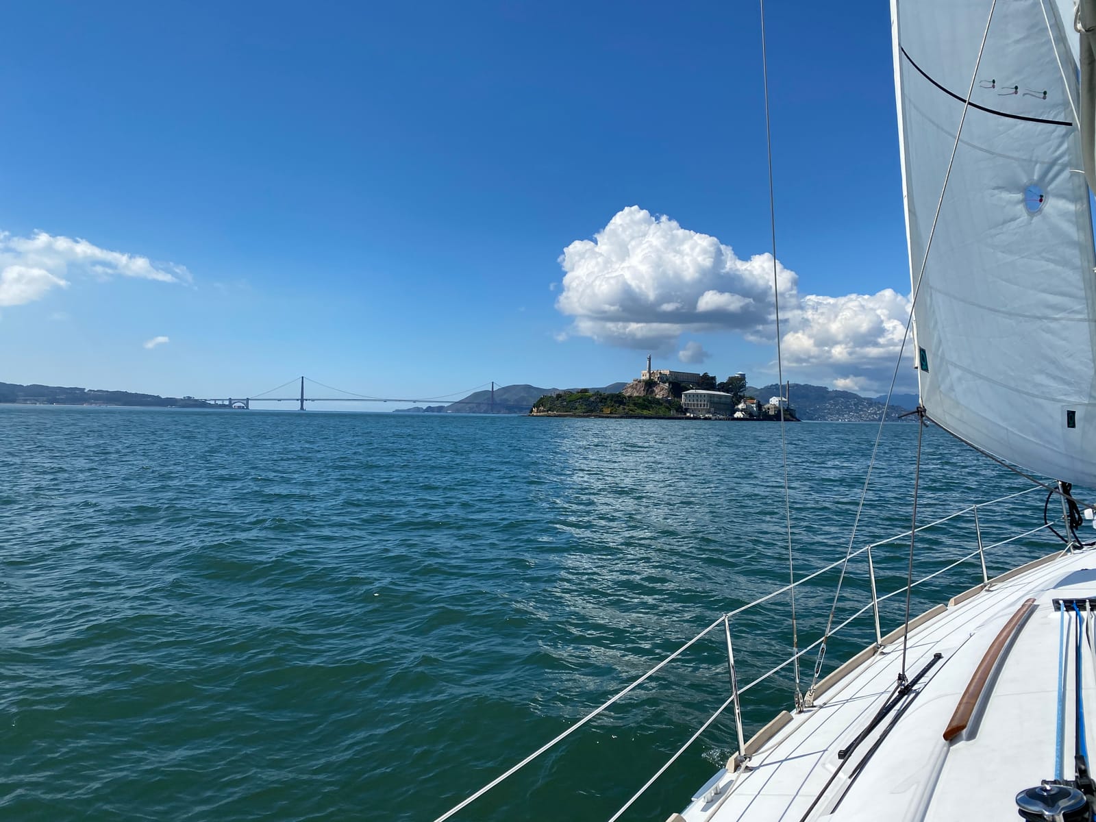 Alcatraz and the Golden Gate Bridge seen from the deck of a sailboat on San Francisco Bay