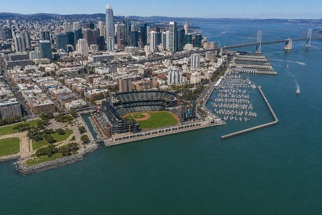 Aerial view of South Beach Harbor and Oracle Park with downtown San Francisco and the Bay Bridge behind